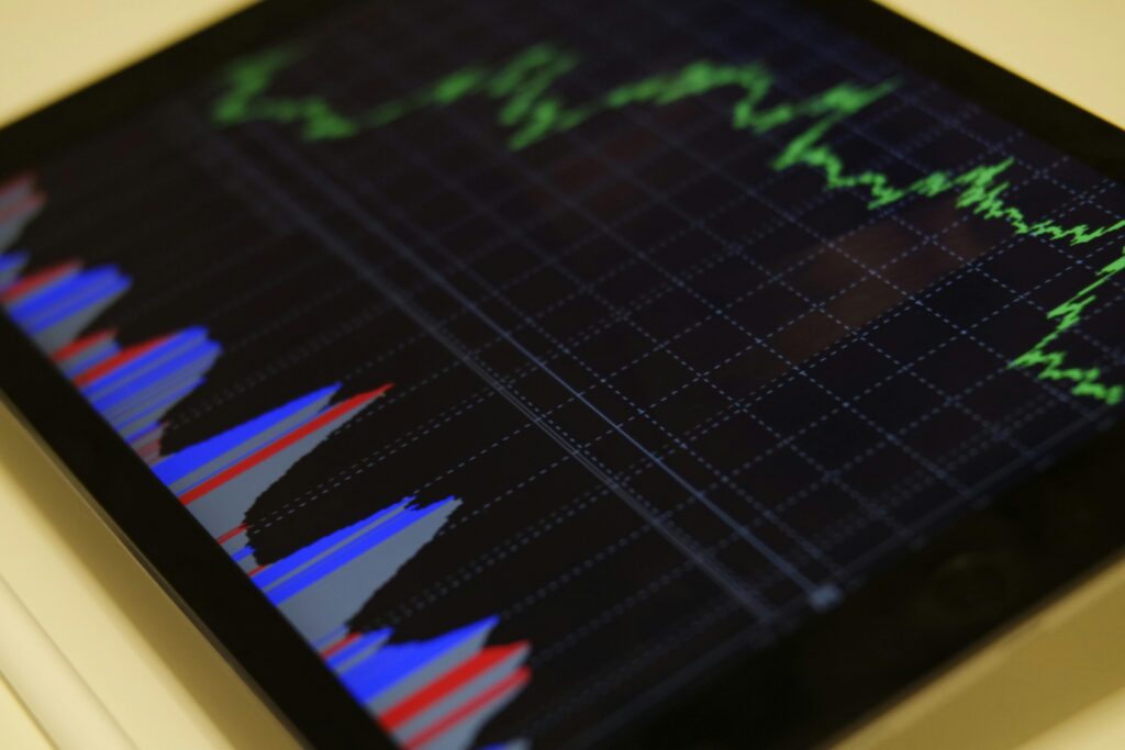 TREND ANALYSIS Close-up of a tablet displaying stock market analysis with colorful graphs.